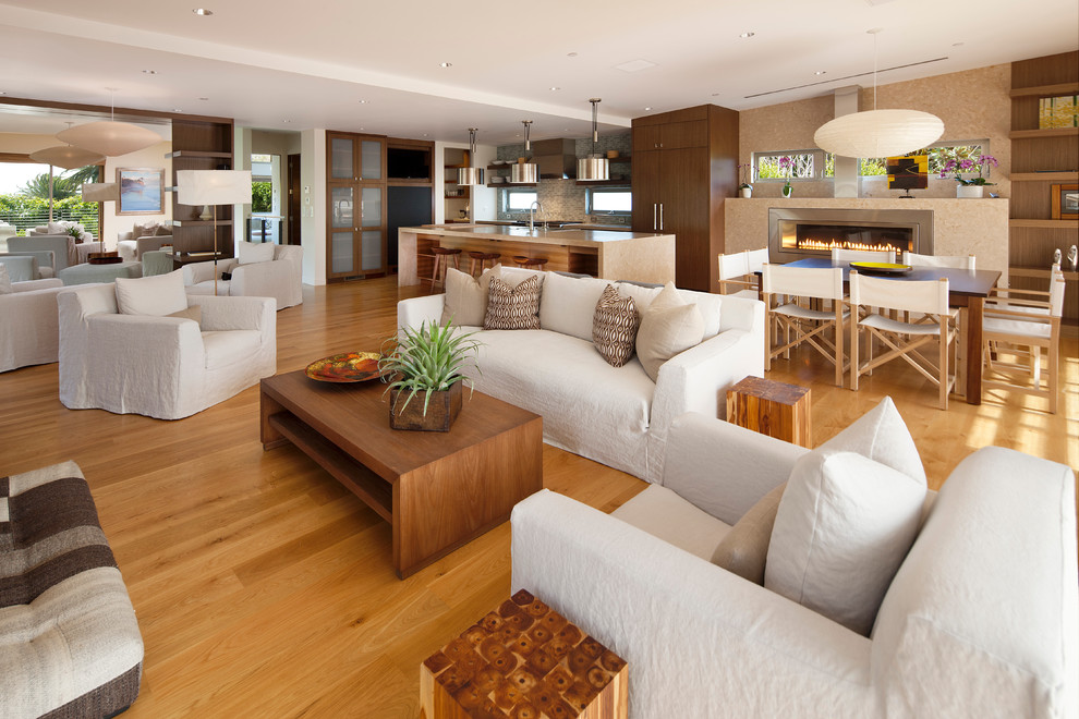 This is an example of a large contemporary open concept family room in Santa Barbara with light hardwood floors, white walls and orange floor.