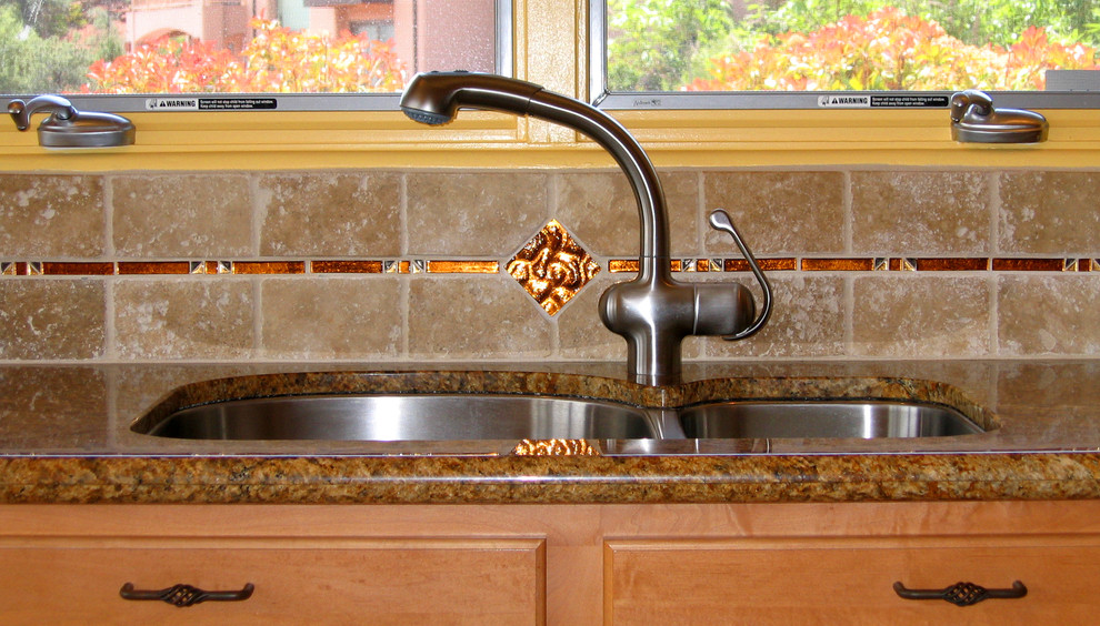 Inspiration for a transitional galley eat-in kitchen remodel in Phoenix with an undermount sink, granite countertops, stone tile backsplash, stainless steel appliances and an island