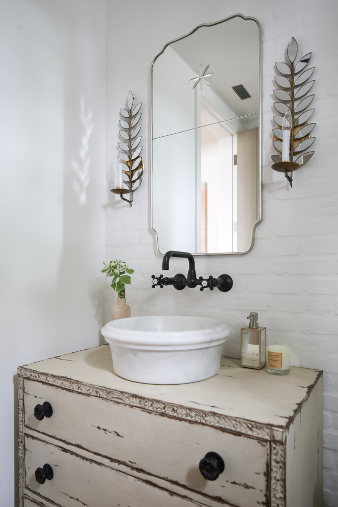 Design ideas for a beach style powder room in Orange County with flat-panel cabinets, distressed cabinets, white tile, white walls and a vessel sink.