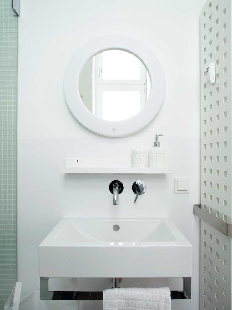 This is an example of a small modern 3/4 bathroom in Berlin with blue cabinets, an open shower, white tile, grey walls, marble floors and grey floor.