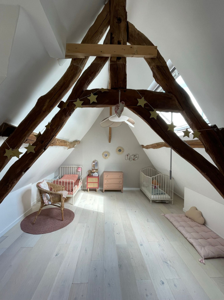 Großes Nordisches Mädchenzimmer mit Schlafplatz, beiger Wandfarbe, hellem Holzboden, beigem Boden, freigelegten Dachbalken und Holzwänden in Paris