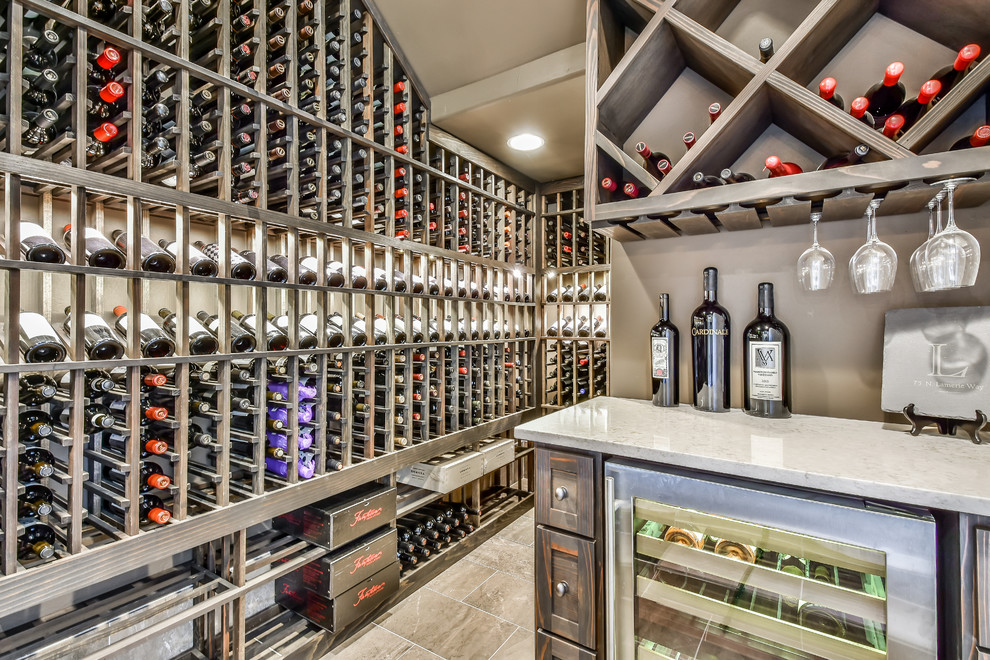 Inspiration for a mediterranean wine cellar in Houston with beige floor.