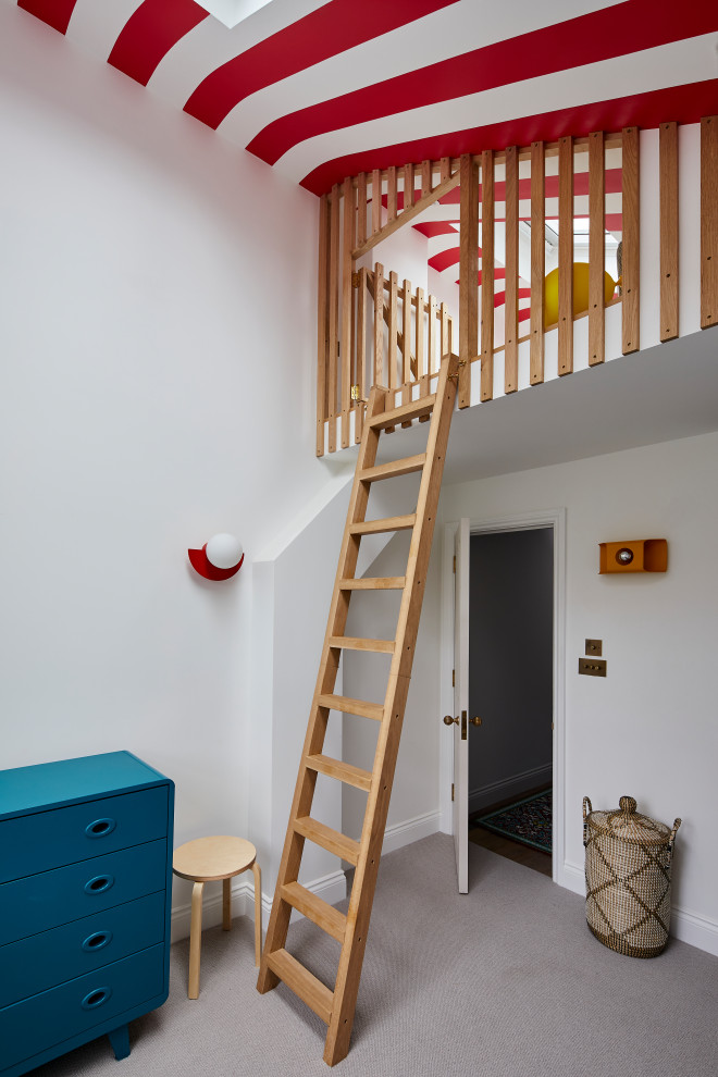 Inspiration for a mid-sized contemporary gender-neutral kids' playroom for kids 4-10 years old in London with white walls, carpet and grey floor.