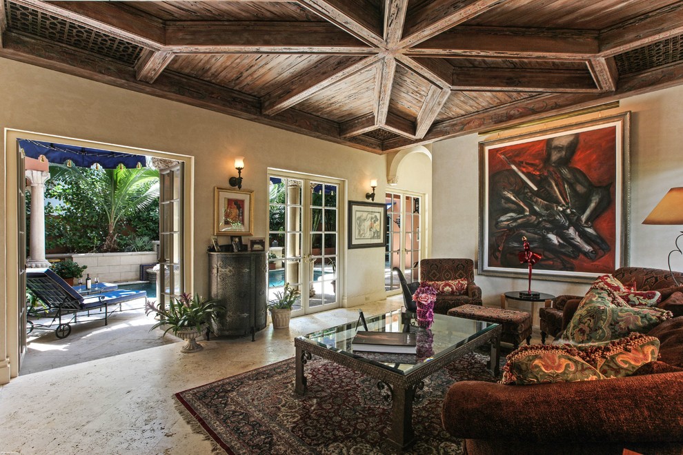 This is an example of a mediterranean family room in Miami with beige walls and no tv.