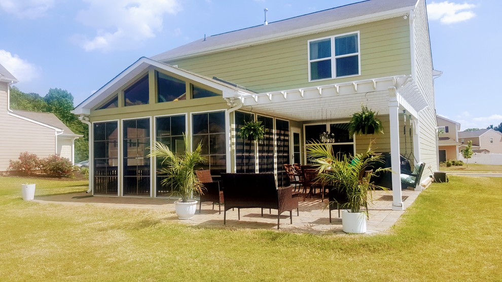 Photo of an arts and crafts backyard screened-in verandah in Charlotte with a pergola.
