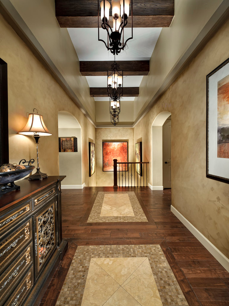 This is an example of a mediterranean hallway in Denver with beige walls and multi-coloured floor.