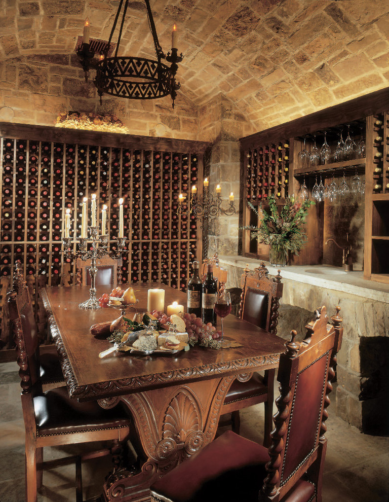 This is an example of a mediterranean wine cellar in Denver with storage racks.