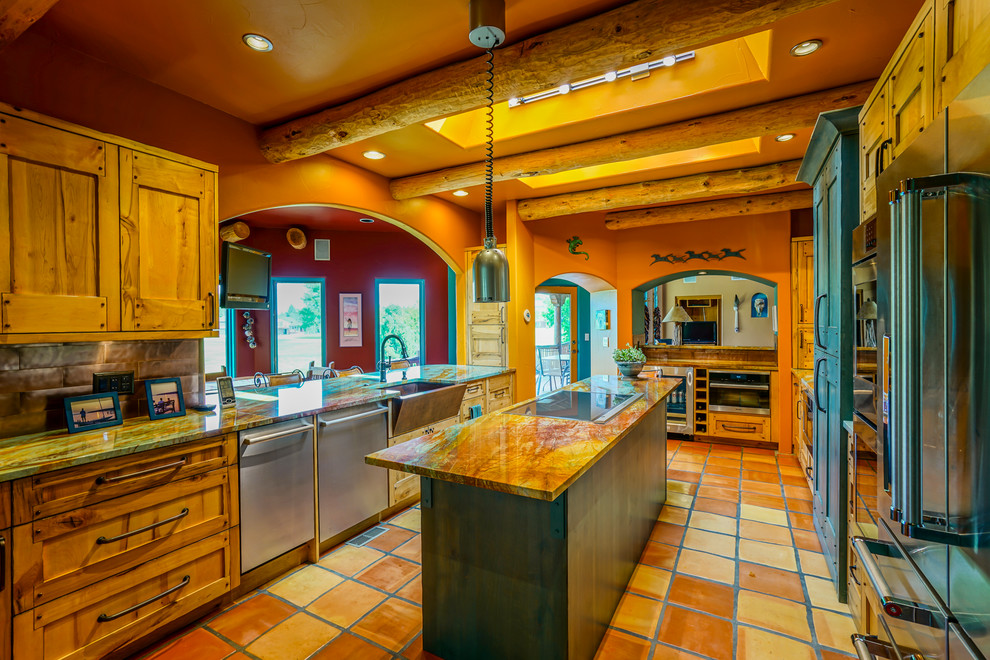 Large galley eat-in kitchen in Denver with a farmhouse sink, flat-panel cabinets, light wood cabinets, granite benchtops, metallic splashback, metal splashback, stainless steel appliances, terra-cotta floors and with island.