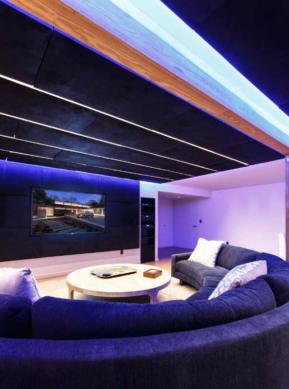 Inspiration for a large modern enclosed home theatre in Baltimore with white walls, a wall-mounted tv and cork floors.