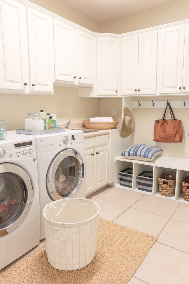 Design ideas for a small transitional l-shaped utility room in Phoenix with a drop-in sink, raised-panel cabinets, white cabinets, laminate benchtops, beige walls, ceramic floors, a side-by-side washer and dryer and beige floor.