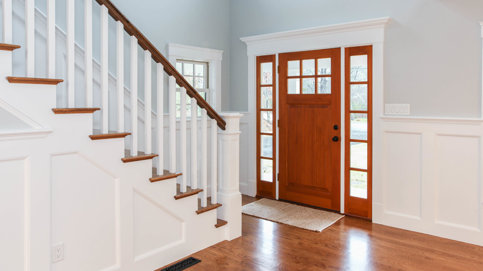Foyer - huge craftsman medium tone wood floor foyer idea with gray walls and a medium wood front door