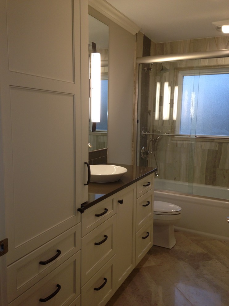 Inspiration for a transitional beige tile and stone tile marble floor alcove bathtub remodel with a vessel sink, flat-panel cabinets, white cabinets, quartzite countertops and beige walls
