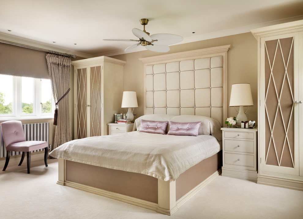 Inspiration for a transitional master bedroom in West Midlands with beige walls and carpet.