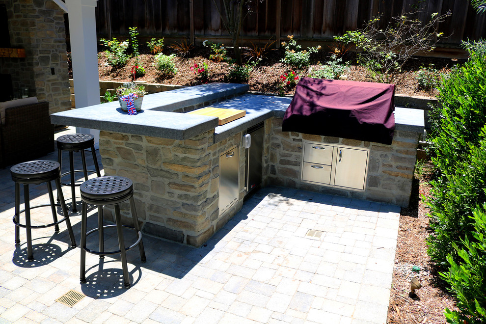 Design ideas for a country backyard patio in Orange County with concrete pavers.