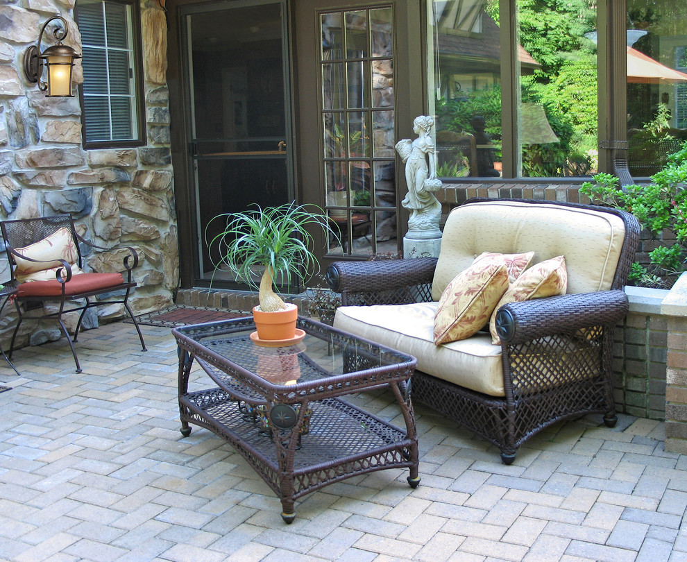 Inspiration for a mid-sized contemporary backyard brick patio remodel in New York with no cover