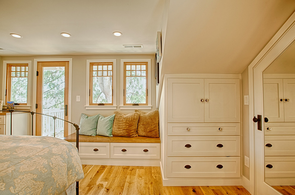 Mid-sized country master bedroom in Seattle with beige walls and light hardwood floors.