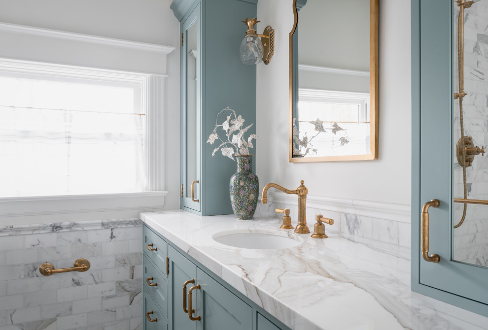 Small elegant 3/4 white tile and marble tile marble floor, white floor, single-sink and wainscoting alcove shower photo in Seattle with beaded inset cabinets, blue cabinets, a bidet, white walls, an undermount sink, marble countertops, a hinged shower door, white countertops, a niche and a built-in vanity
