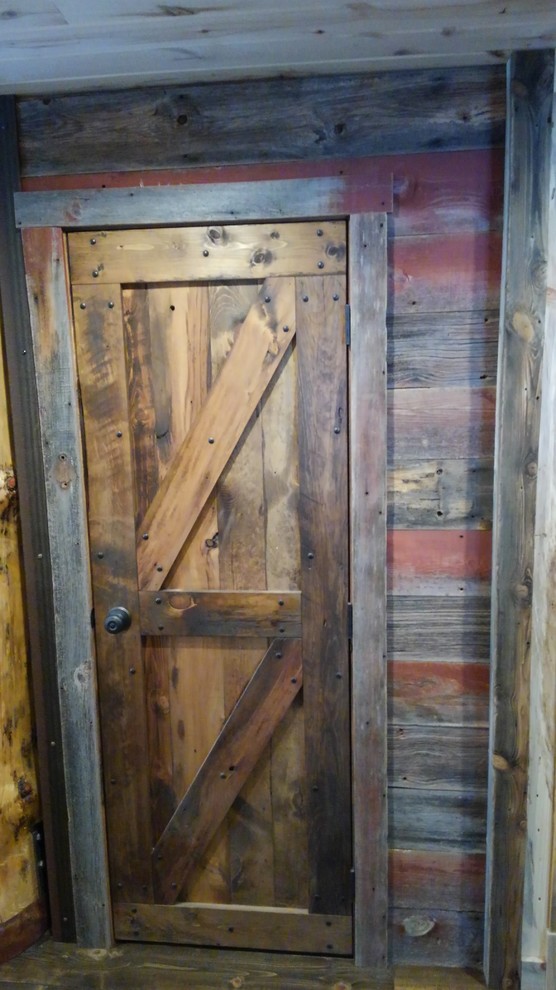 Example of a small mountain style front door design with a medium wood front door