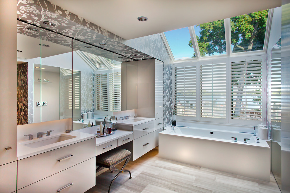 Inspiration for a large contemporary master bathroom in Minneapolis with an undermount sink, flat-panel cabinets, grey cabinets, engineered quartz benchtops, an undermount tub, a curbless shower, a one-piece toilet, gray tile, stone tile and limestone floors.