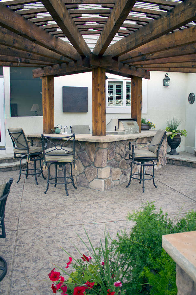 Design ideas for a large country backyard patio in Denver with natural stone pavers and a pergola.