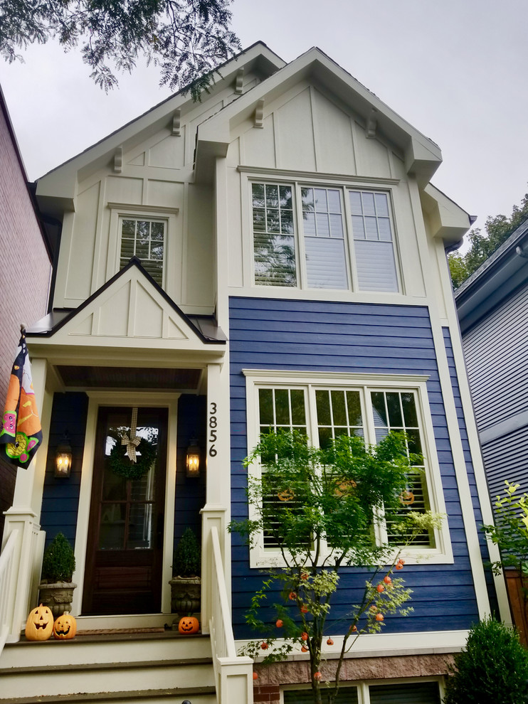 Inspiration for a large traditional three-storey blue duplex exterior in Chicago with concrete fiberboard siding, a gable roof and a shingle roof.