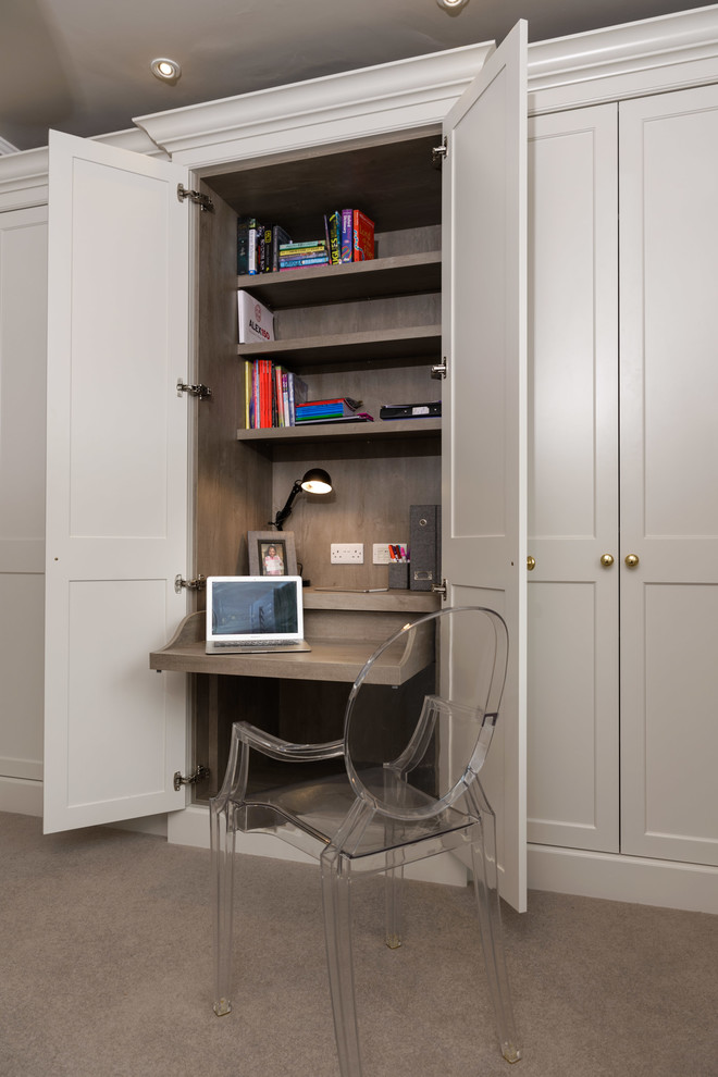 This is an example of a transitional study room in Dublin with carpet and a built-in desk.