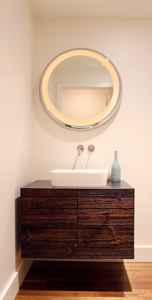 This is an example of a contemporary powder room in Denver with dark wood cabinets, a vessel sink and furniture-like cabinets.