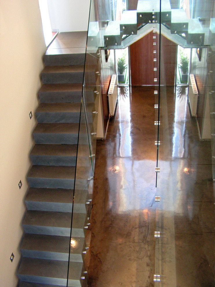 This is an example of a large l-shaped staircase in Other with glass railing.