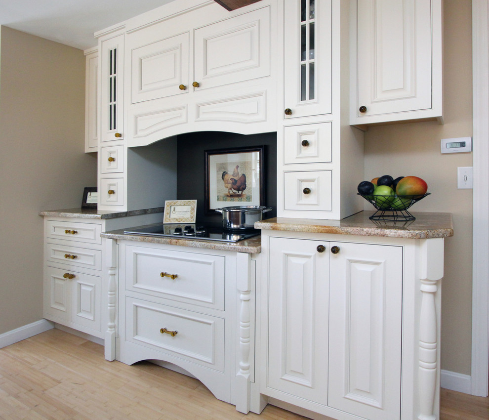 Traditional kitchen in Boston with beaded inset cabinets and white cabinets.