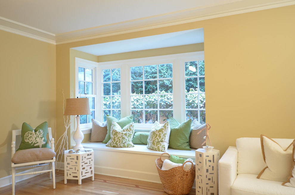 Photo of a mid-sized beach style enclosed living room in Portland with beige walls, light hardwood floors and no tv.