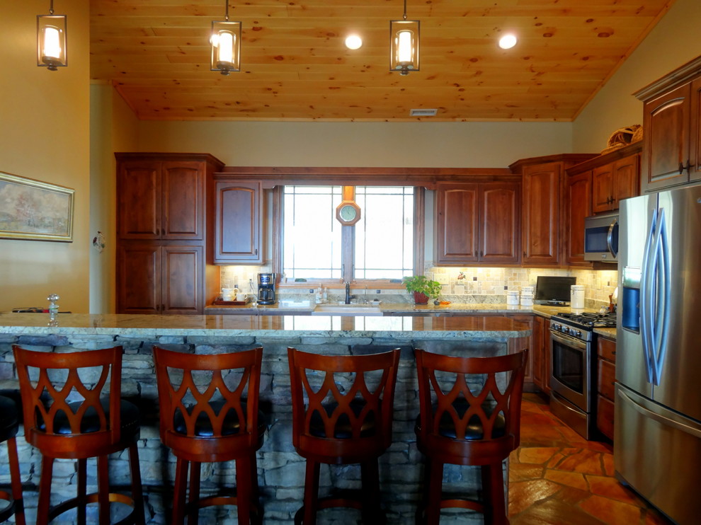 Inspiration for a mid-sized rustic l-shaped slate floor open concept kitchen remodel in Charlotte with a farmhouse sink, raised-panel cabinets, dark wood cabinets, granite countertops, multicolored backsplash, ceramic backsplash, stainless steel appliances and a peninsula