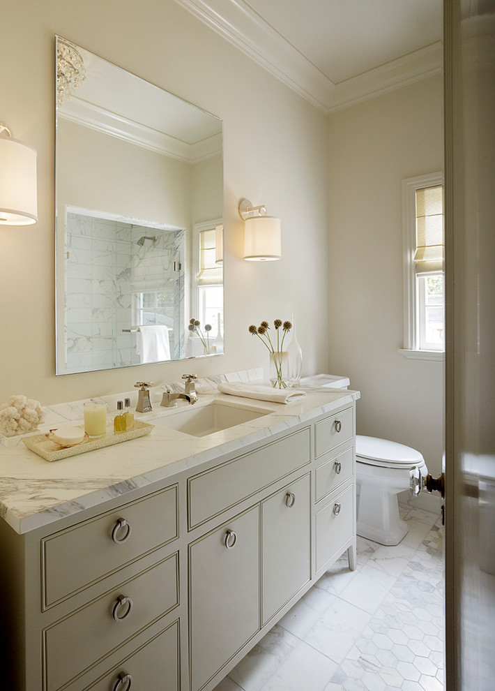 Photo of a transitional bathroom in San Francisco with beaded inset cabinets, an undermount sink and beige cabinets.