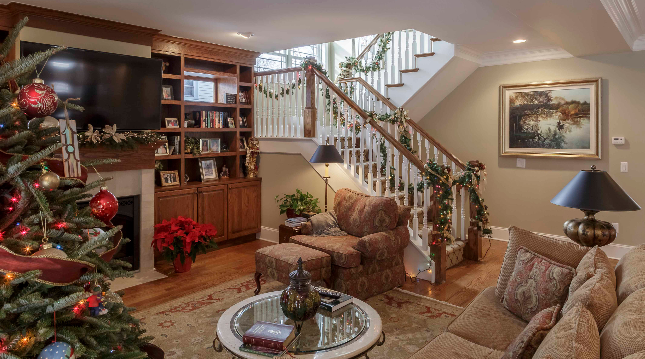 Example of a mid-sized arts and crafts open concept and formal medium tone wood floor, brown floor, wallpaper ceiling and wallpaper living room design in Detroit with beige walls, a standard fireplace