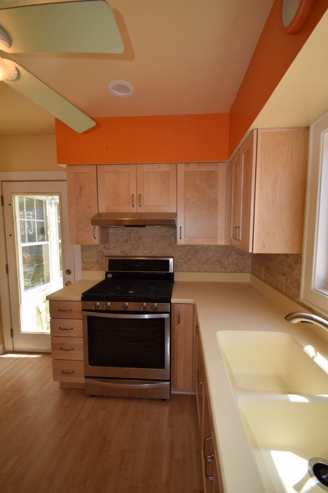 Example of a mid-sized transitional u-shaped light wood floor kitchen design with an integrated sink, shaker cabinets, light wood cabinets, multicolored backsplash, stone tile backsplash, a peninsula and white countertops
