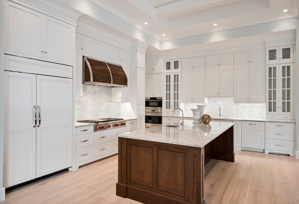 Open concept kitchen - transitional light wood floor open concept kitchen idea with stainless steel appliances and an island