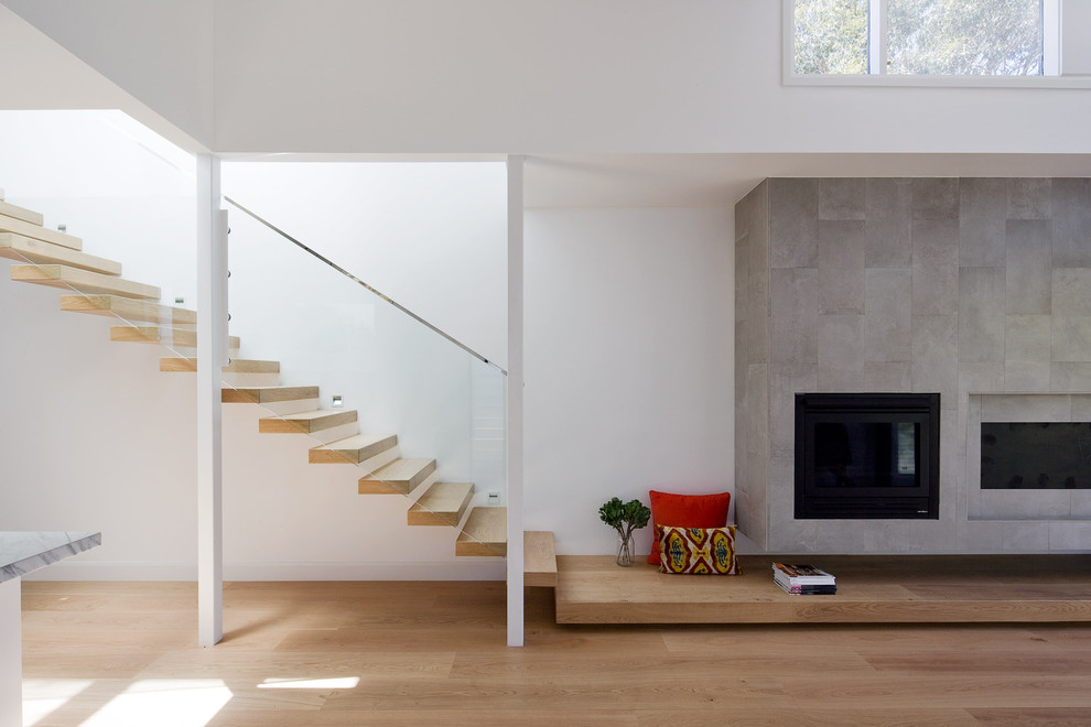 Photo of a contemporary wood straight staircase in Sydney with open risers.
