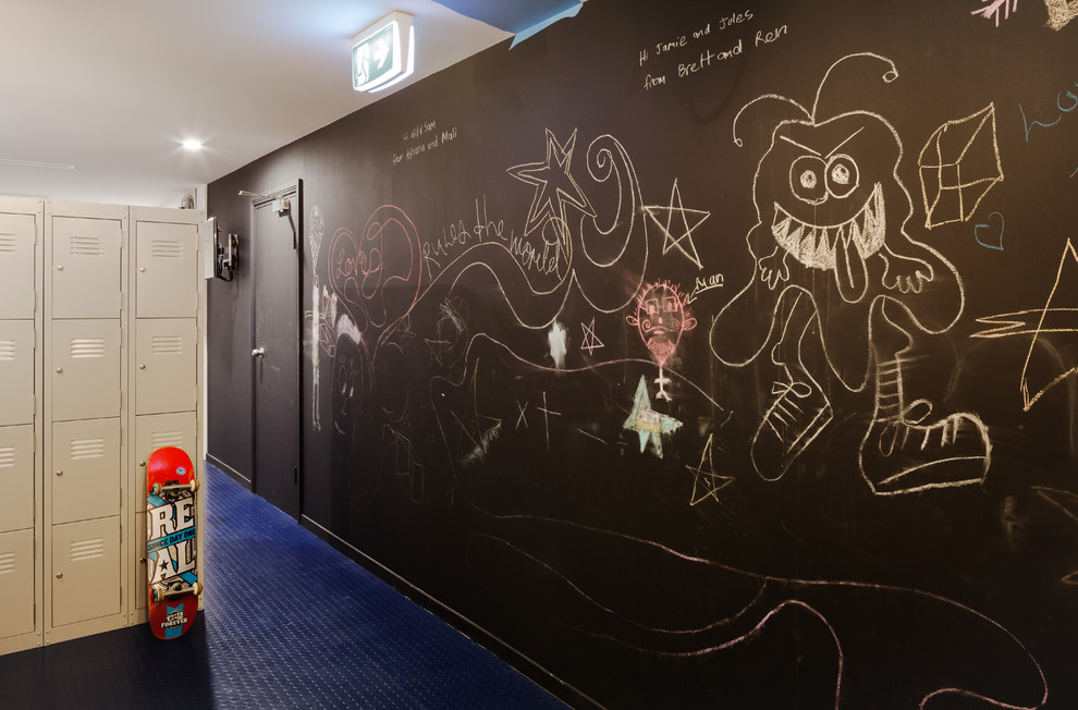 Expansive industrial gender-neutral kids' room in Sydney with multi-coloured walls, linoleum floors and blue floor.