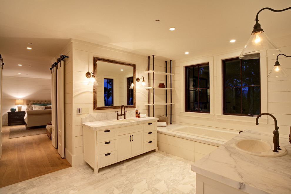 Bathroom - mid-sized cottage master beige tile and stone slab ceramic tile bathroom idea in San Francisco with marble countertops, flat-panel cabinets, medium tone wood cabinets, a one-piece toilet, beige walls and a drop-in sink