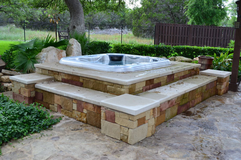 Large arts and crafts backyard patio in Austin with a water feature and no cover.