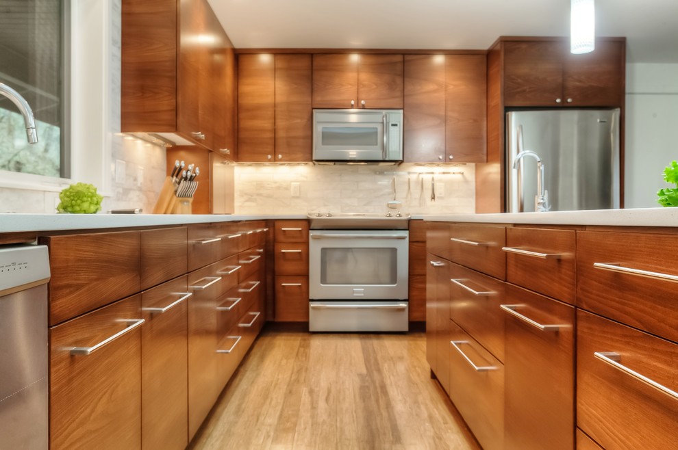 Design ideas for a large midcentury eat-in kitchen in Portland with a double-bowl sink, flat-panel cabinets, medium wood cabinets, quartz benchtops, white splashback, marble splashback, stainless steel appliances, bamboo floors, with island, brown floor and white benchtop.