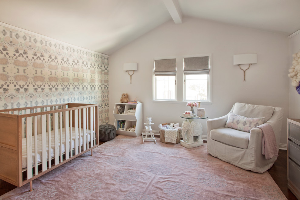 Inspiration for a transitional nursery for girls in San Francisco with pink walls, dark hardwood floors and pink floor.