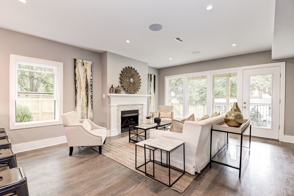 Mid-sized transitional open concept family room in DC Metro with grey walls, medium hardwood floors, a standard fireplace, a tile fireplace surround, no tv and brown floor.