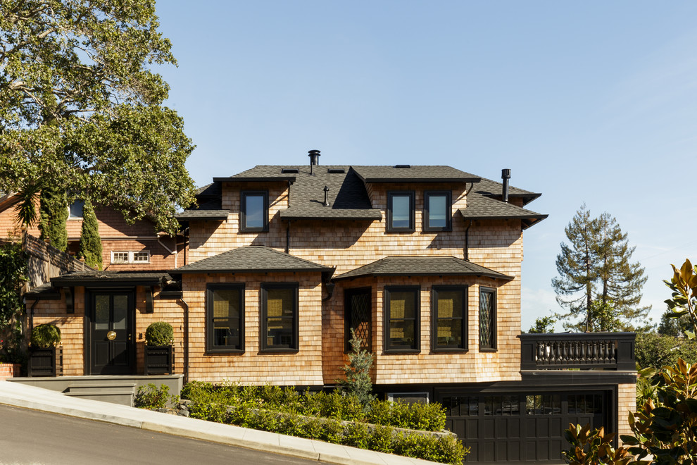 This is an example of a large traditional two-storey exterior in San Francisco with wood siding and a hip roof.