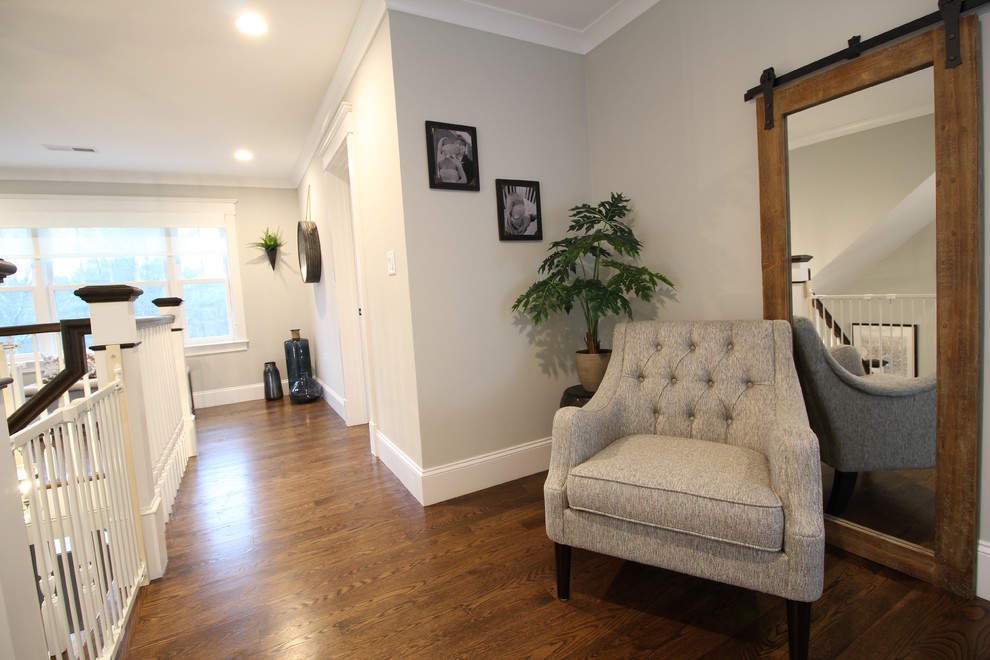 Inspiration for a large transitional dark wood floor and brown floor hallway remodel in Boston with gray walls