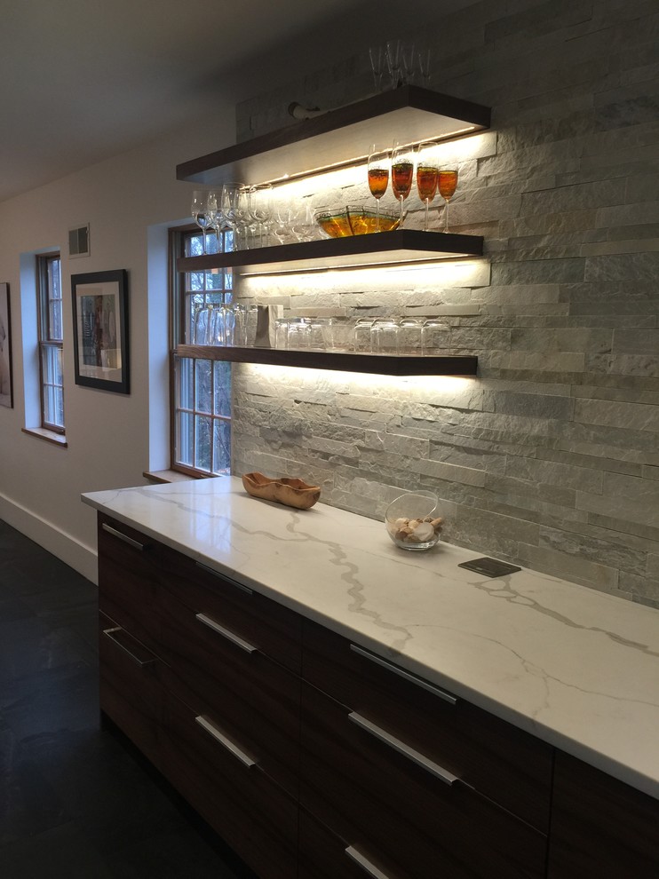 Design ideas for a modern single-wall home bar in New York with quartzite benchtops, porcelain floors, flat-panel cabinets, medium wood cabinets and stone tile splashback.