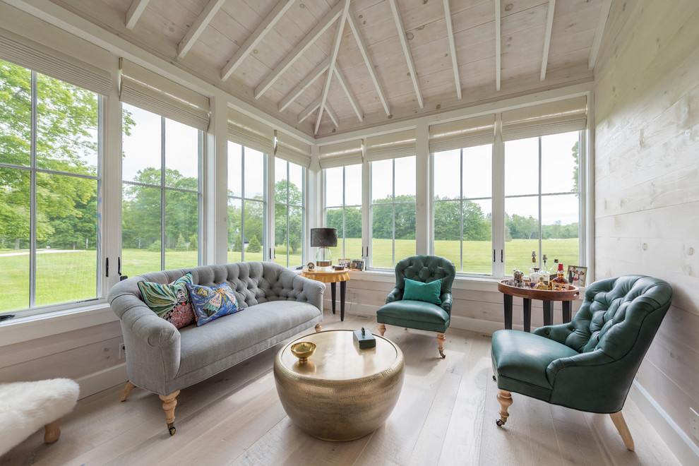 This is an example of a mid-sized traditional sunroom in New York with light hardwood floors, no fireplace and beige floor.