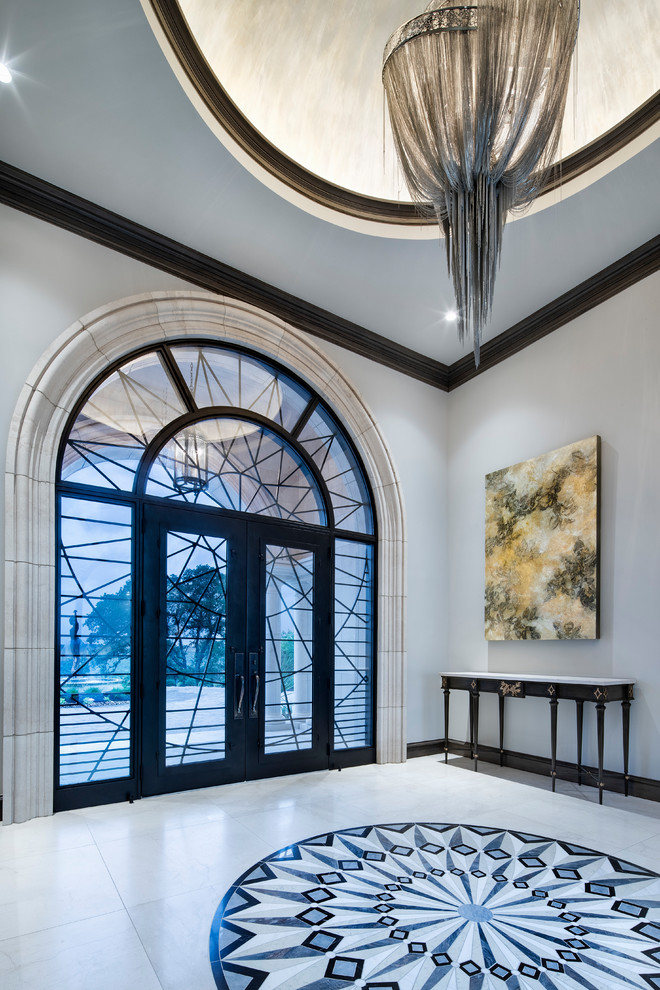 Photo of a large mediterranean foyer in Austin with grey walls, a double front door, white floor and a glass front door.