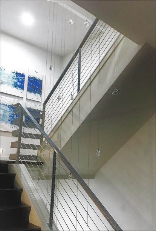 Example of a large transitional u-shaped metal railing staircase design in Denver