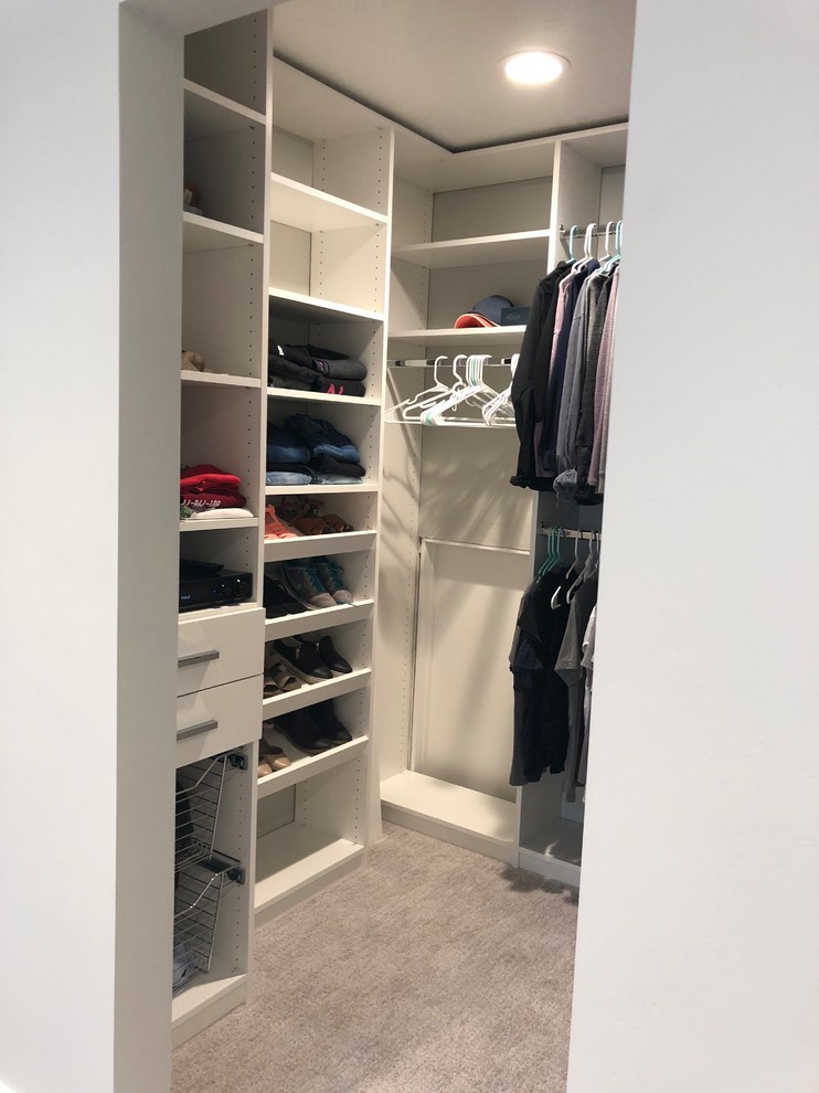 Photo of a small modern women's walk-in wardrobe in Salt Lake City with flat-panel cabinets, white cabinets, carpet and grey floor.