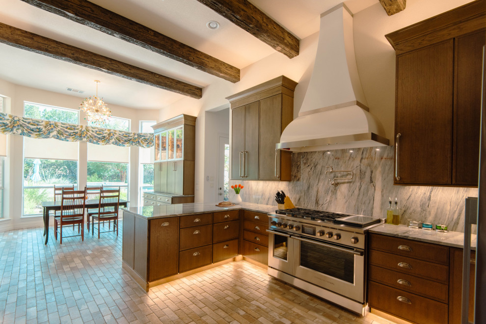 Example of a large transitional u-shaped brick floor, brown floor and exposed beam eat-in kitchen design in Austin with shaker cabinets, medium tone wood cabinets, quartzite countertops, blue backsplash, stainless steel appliances, a peninsula and blue countertops
